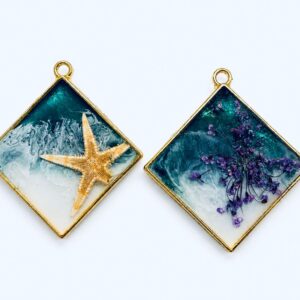 Resin pendants featuring a starfish and purple flowers, handcrafted jewellery by Encore Creations.
